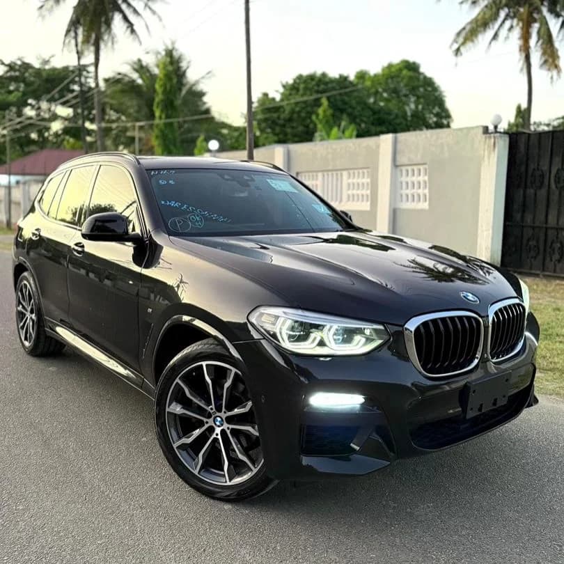 Black BMW X3 luxury SUV, three-quarter front view with LED headlights