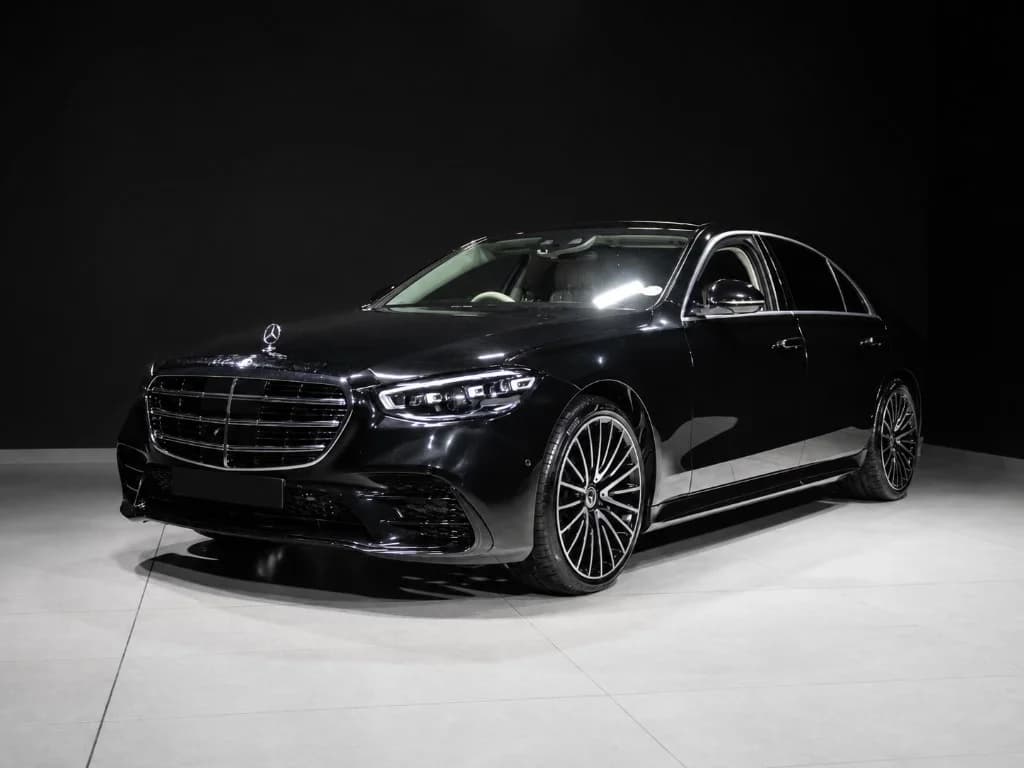 Black Mercedes-Benz S-Class luxury sedan, three-quarter front view